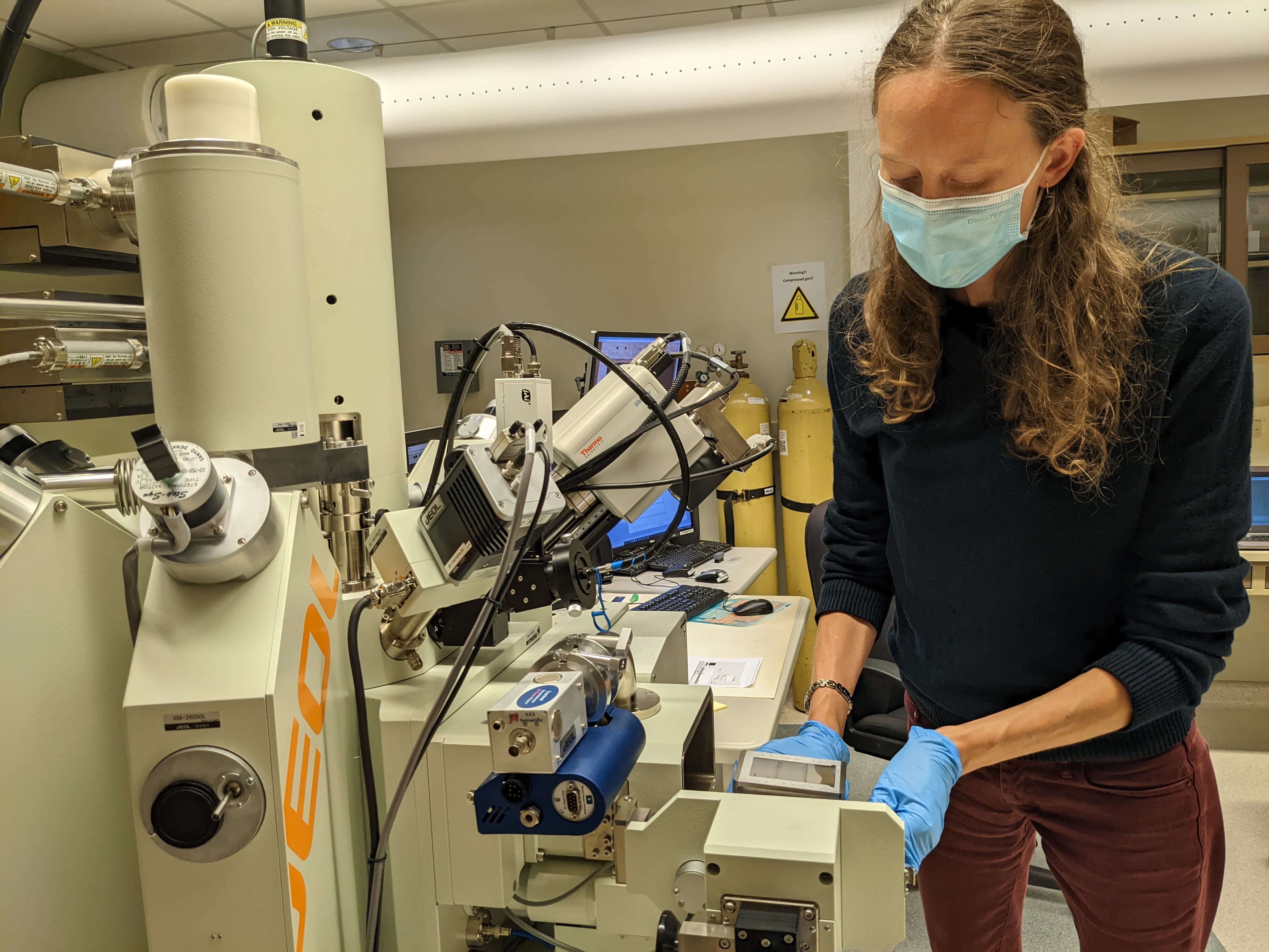 Dr Erica Barlow studying rocks in a lab